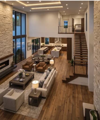 A two-story great room with a floating staircase, open to the kitchen and the pool beyond